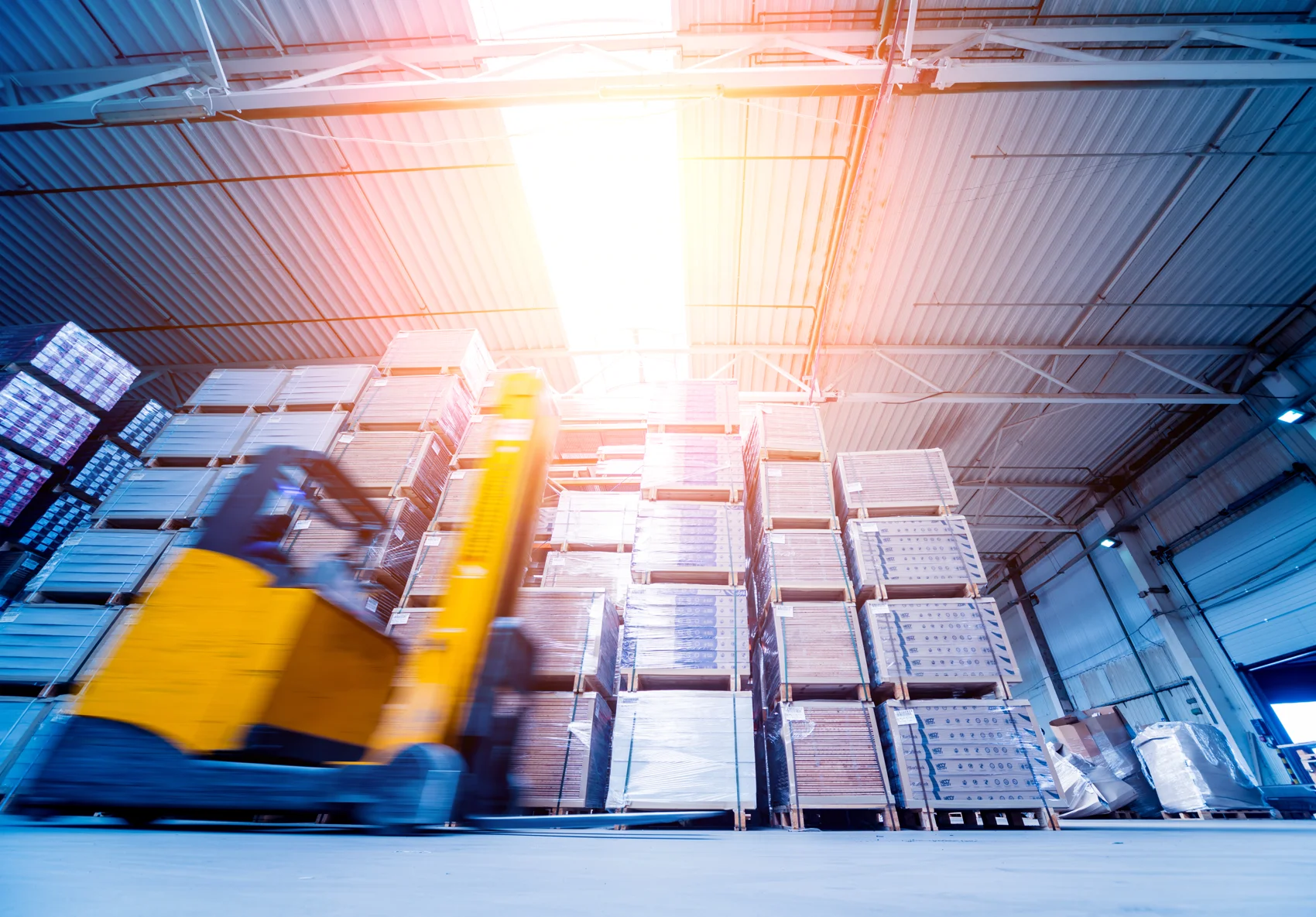 Forklift moving inventory in a storage warehouse