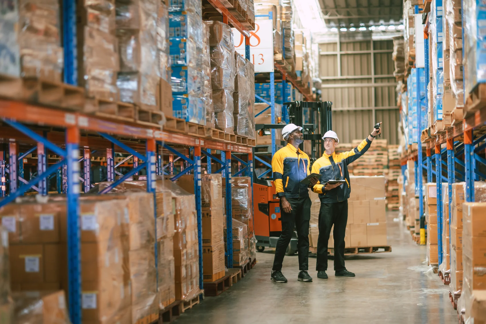 Warehouse employees managing inventory together